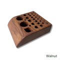 Temperance & Penn Tool Holder crafted from walnut wood, featuring multiple sized circular holes and a sloped design to organize fishing tackle tools efficiently.
