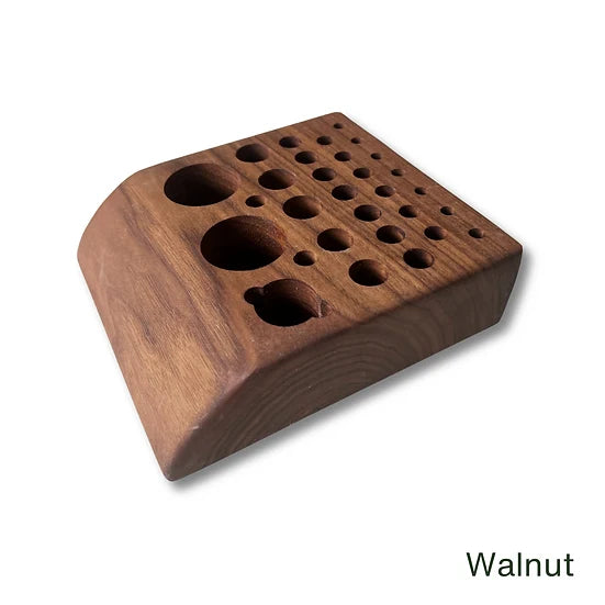 Temperance & Penn Tool Holder crafted from walnut wood, featuring multiple sized circular holes and a sloped design to organize fishing tackle tools efficiently.