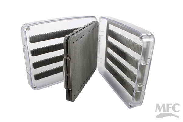 Clear plastic fly box with foam inserts and multiple rows of slits for organizing fishing flies, shown open to display internal compartments, labeled TFC Tandem Dropper Rig Fly Box.