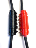 Close-up of black and red cable connectors with TH Marine branding on thick black battery cables, part of the TH Marine HYDRA Battery Cable Extender HCE-K-DP for marine electronics and fishing tackle use.