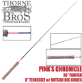 Thorne Bros Custom Ice Rod - Crappie Chronicles "Pink's Chronicle" features a 36-inch panfish rod with a pink and navy blue blank, cork handle, and eight outside reel guides designed for ice fishing.