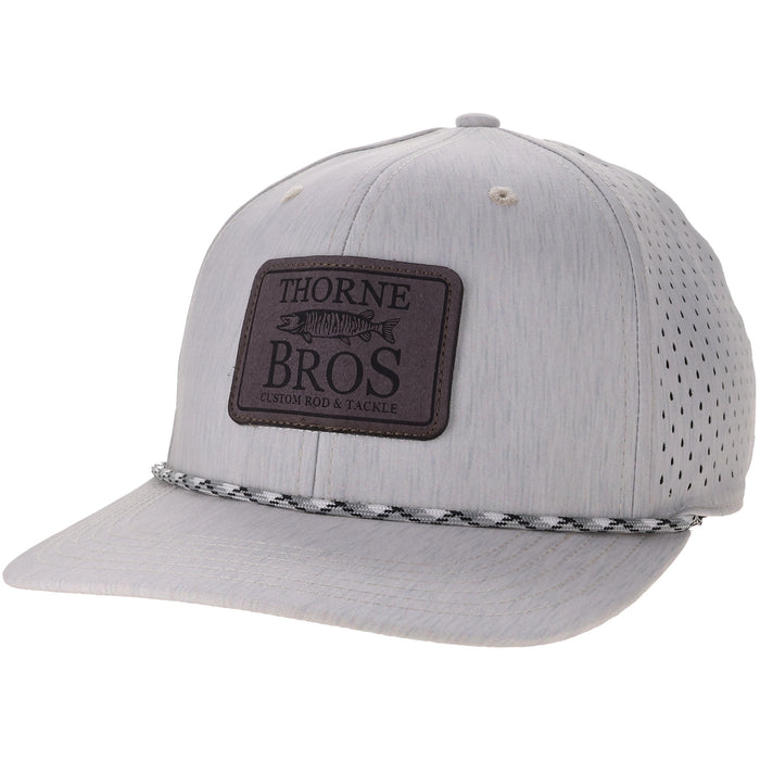 Thorne Bros. Legacy Reclaim Rempa Mid-Pro light gray fishing hat featuring a perforated breathable back panel, black embroidered logo patch, and braided rope detail on the brim.