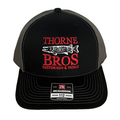 Thorne Bros. Logo Richardson 112 Embroidered cap in black and gray mesh with red and white fishing-themed logo featuring a musky fish and custom rod and tackle text.