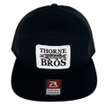 Black mesh snapback cap with flat bill featuring a white rectangular patch embroidered with "Thorne Bros" and a fish graphic, labeled as Thorne Bros Richardson 168 Thorne Bros Patch.