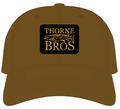 Thorne Bros Richardson 309 Thorne Bros Patch on a brown fishing hat featuring a black and gold embroidered logo with a musky fish design.