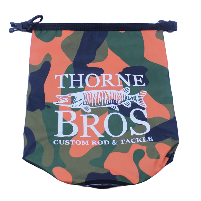 Thorne Bros. Waterproof Dry Bag in green, black, and orange camouflage pattern with a white musky fish logo and zippered top closure for fishing tackle storage.