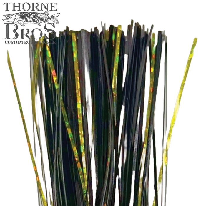 Close-up of Thorne Brothers Pre-Tied Tinsel Skirt-Blended Tinsel featuring shiny black and iridescent green strands designed for fishing lures and tackle enhancement.