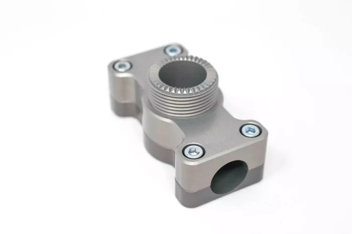 Metallic gray component with threaded central circular opening and four screws designed for mounting, identified as TKI ROD HOLDER BASES 7/8" Round Rail Base.