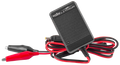Vexilar Lithium Battery Chargers (Charger Only) featuring a compact black charger box with ribbed texture and attached red and black alligator clip cables for marine electronics and fishing tackle use.