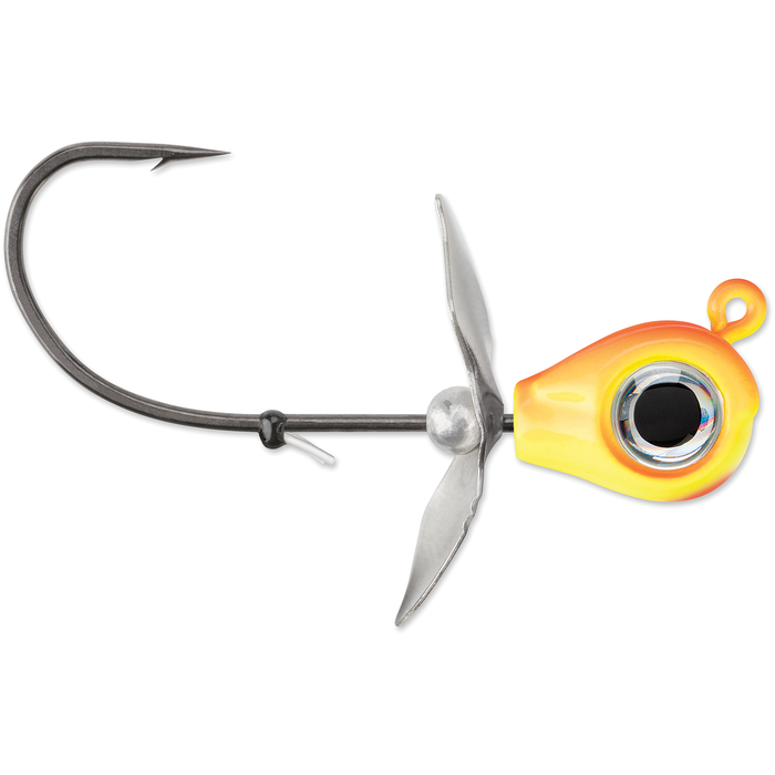 VMC Snitch Jig fishing lure with an orange and yellow weighted head, lifelike eye detail, sharp single hook, and metal propeller blades for enhanced water movement.