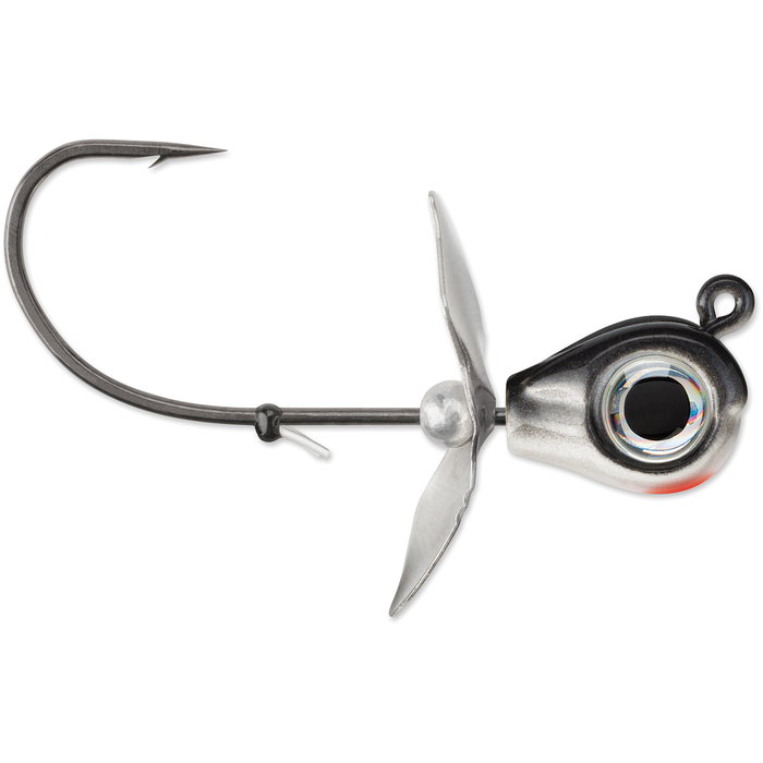 VMC Snitch Jig fishing lure featuring a single sharp hook, a metallic weighted head with a realistic eye design, and a propeller blade for added water movement.