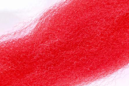 Close-up of bright red Wapsi Fuzzy Fiber material showing fine, soft, and fuzzy synthetic fibers used for fly fishing lures and fishing tackle.