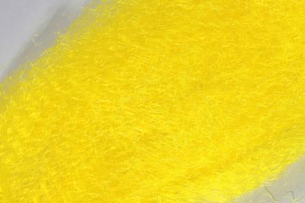 Close-up of bright yellow synthetic fibers with a fuzzy texture used in fishing tackle applications, showing detail of the Wapsi Fuzzy Fiber material.