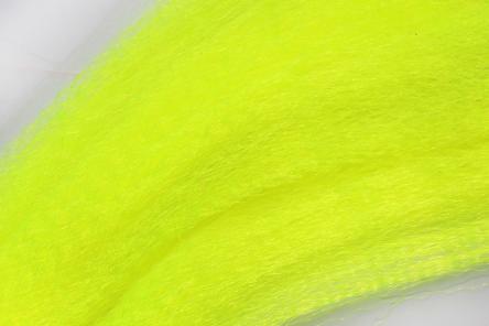 Close-up of bright yellow synthetic fibers labeled Wapsi Fuzzy Fiber used for crafting fishing lures and other fishing tackle applications.