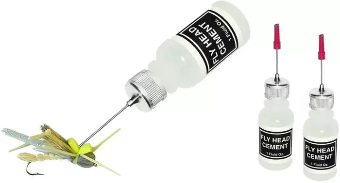 Clear plastic bottle of Wapsi Head Cement - Applicator Bottle with metal needle tip, shown applying adhesive to a fishing lure for secure fly fishing tackle assembly.