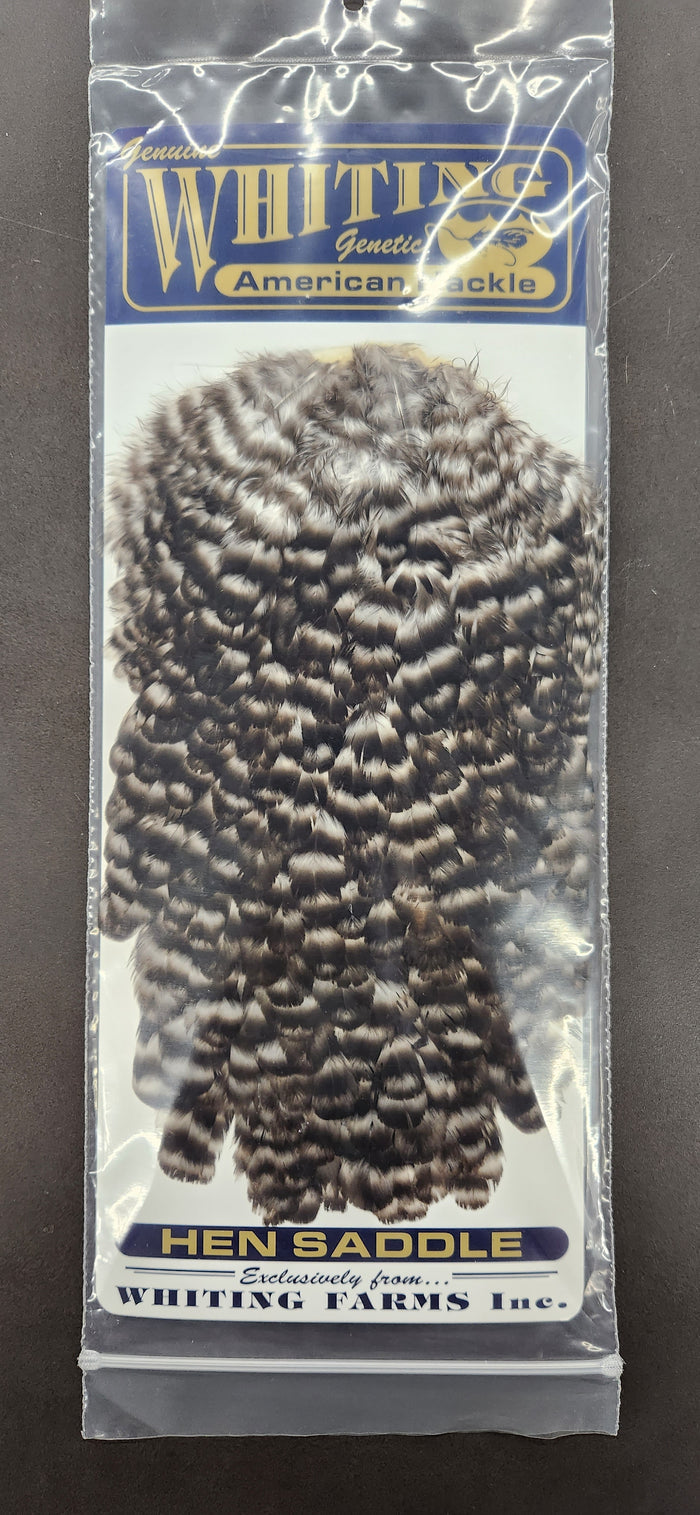 Whiting American Hen Saddle featuring natural spotted brown and white feathers packaged for fly fishing tackle and lure crafting.