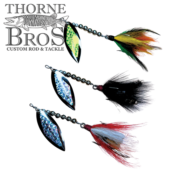 Three Windels Magnum Pike Harasser fishing lures with feathered tails in yellow, black, and red, each featuring a reflective, curved blade and metal bead chain.