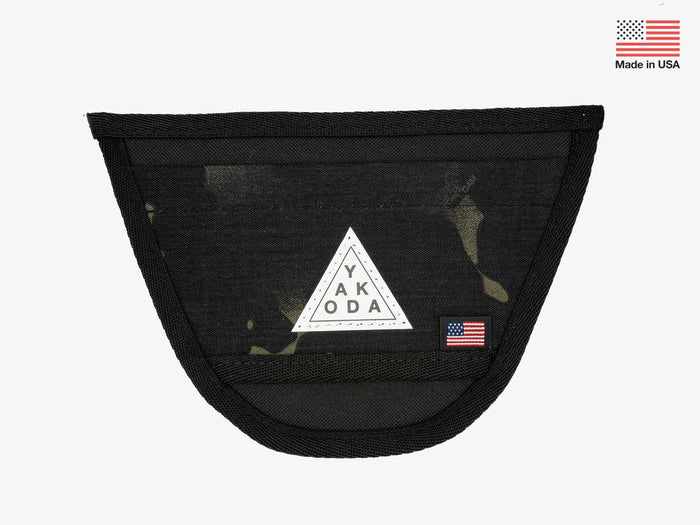 Yakoda Net Holster in black with a subtle multicam pattern, made of durable mesh and fabric, featuring a triangular logo patch and a small American flag tag.