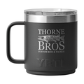 Yeti Thorne Bros. Logo Rambler 10oz. Mug - w/ MagSlider Lid in matte black with Thorne Bros. logo and fish graphic, stainless steel rim, and black handle for fishing enthusiasts.