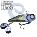 Zilla Baits Gladiator (Mini & Standard) fishing lure with a curved white tail, metallic green and silver body, and two sharp treble hooks, designed for musky fishing.