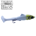 Zilla Baits Hooker fishing lure in white and yellow with realistic eyes and a soft paddle tail, designed for musky and freshwater fishing.