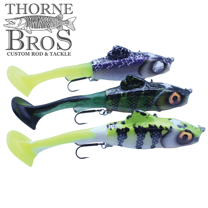 Three Zilla Baits Junior Hooker fishing lures in yellow, green, and purple patterns with detailed eyes and hook attachments, displayed with the Thorne Bros custom rod and tackle logo.