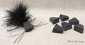 Black Zudbubbler Popper Bodies fishing lure components with textured surfaces and feathered accents, designed for musky and fly fishing tackle.